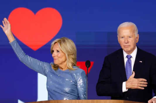 Jill and Joe Biden acknowledge applause after the president's speech during the first day of the 2024 DNC.