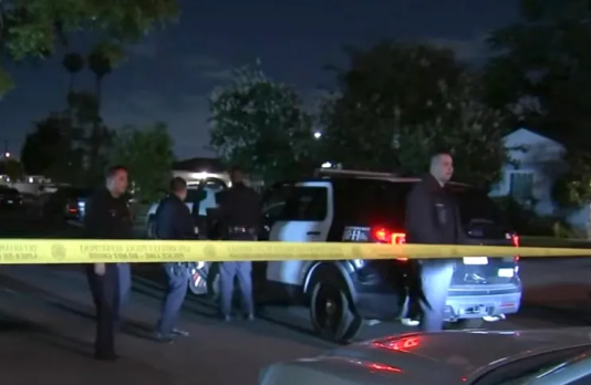 The scene outside a home where two adults and two children were found dead.